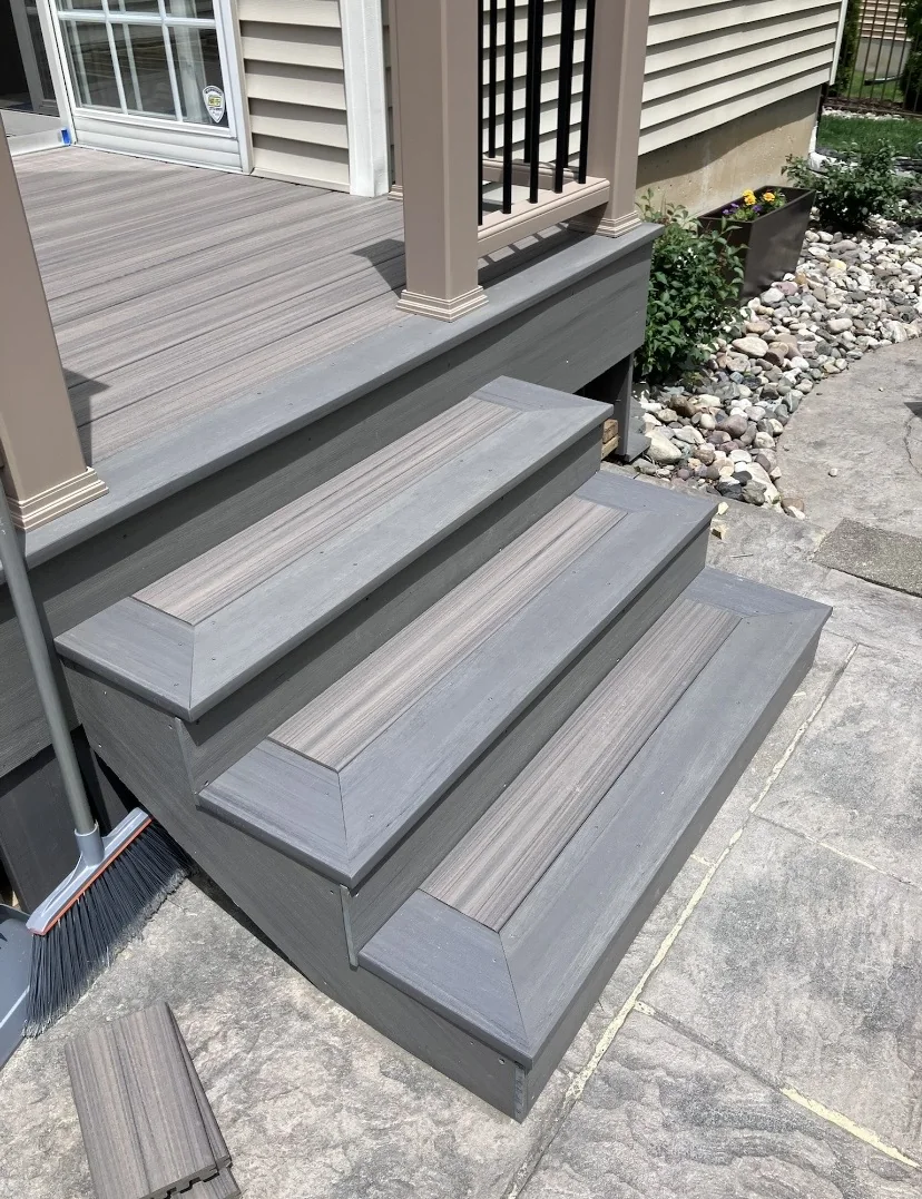 Exterior entry steps with grey decking and white trim