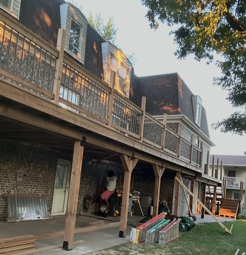 Raised wood deck with railings viewed from the yard