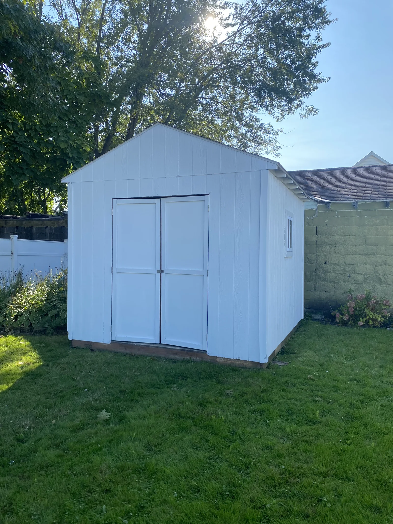 White garden shed with double doors