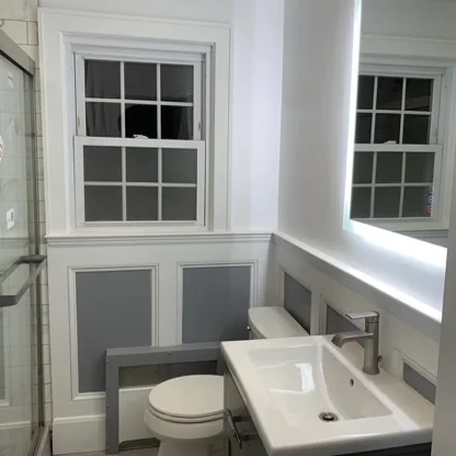 Bathroom vanity and panelled wall under a window