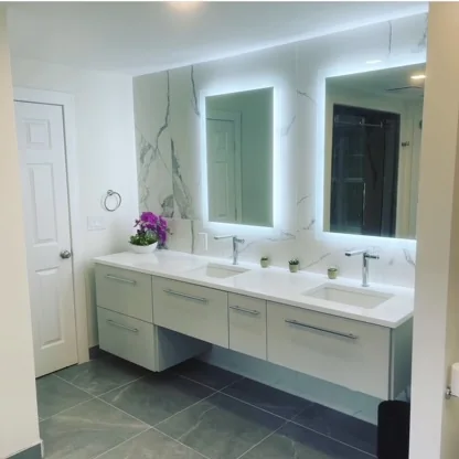 Double vanity with illuminated mirrors and white cabinetry