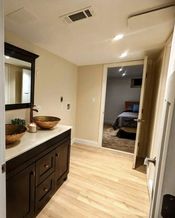 Bathroom doorway showing wood vanity and wood-look floor