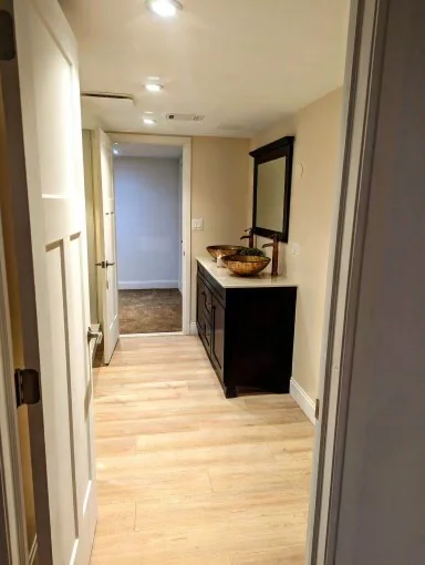 Bathroom with dark wood vanity and a tiled shower beyond